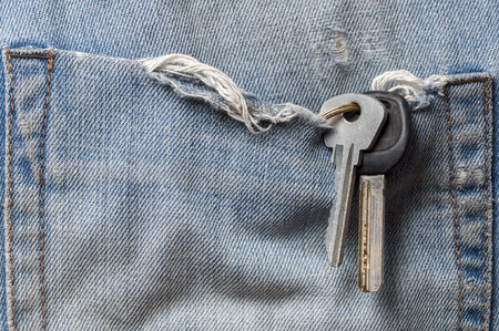 The keys in the pocket of old jeans close upの写真素材