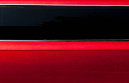 Detail of the red car with dark windowsの写真素材