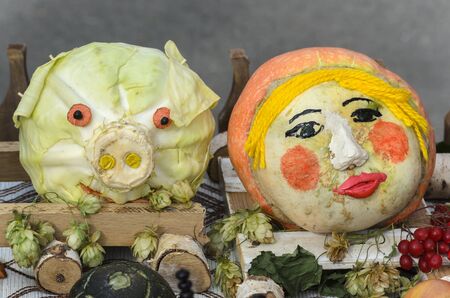 Pumpkin as a person and cabbage in the form of the head of the pig autumn compositionの写真素材