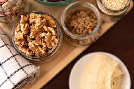 small jar with mixed nuts on rustic table top view. Healthy food and snack.