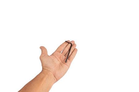Black male hand offering an allen key isolated on white backgroundの写真素材