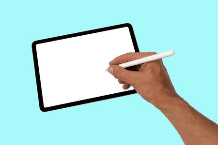 Male hand drawing or writing on a tablet blanc screen with smart pencil cyan backgroundの写真素材