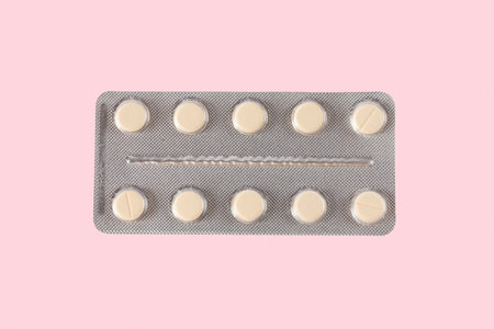 Medicine pill blister isolated on pink backgroundの写真素材