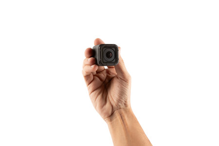 Male hand holding an action camera isolated on white background front view