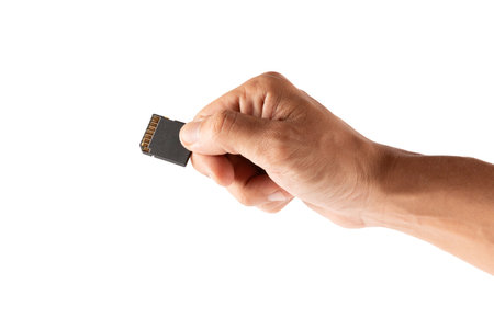 Hand holding an SD memory card isolated on white backgroundの写真素材