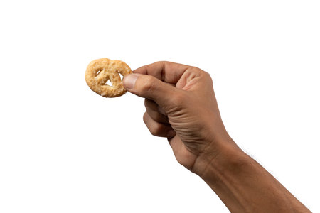 Hand holding a sugared biscuit isolated no backgroundの写真素材