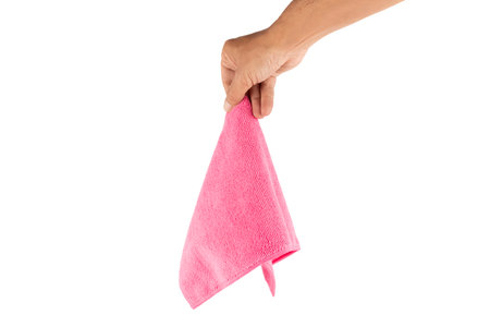 Male hand holding a pink cleaning cloth isolated on white backgroundの写真素材