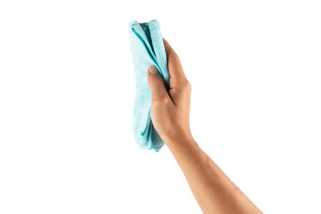 Male hand using a cyan cleaning cloth isolated no backgroundの写真素材