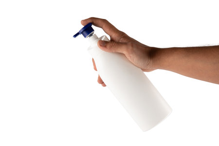 Male hand holding moisturizer dispenser mockup isolated on white background cutoutの写真素材