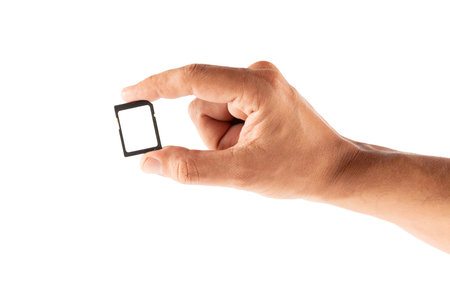 Male hand holding an SD memory card mockup isolated no background