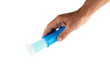 Male hand holding cyan toilet deodorant dispenser isolated no background cutoutの写真素材