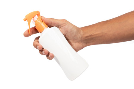 Male hand holding sunscreen cream spray mockup isolated on white background cutoutの写真素材