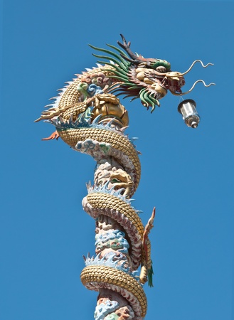 Ancient Chinese Dragon statue  against blue skyの写真素材