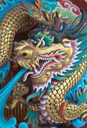 Ancient Chinese Dragon statue  against blue skyの写真素材