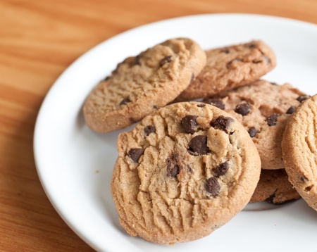 chocolate chips cookies in a dish on  the wood teble.の写真素材