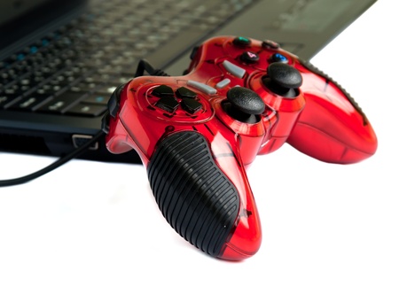 red joystick game controller on laptop  isolated on white background.