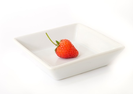 red ripe strawberries  on a white dish.の写真素材