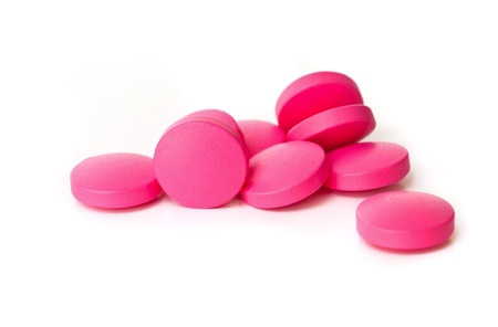 Red medical  pills  on white background.の写真素材