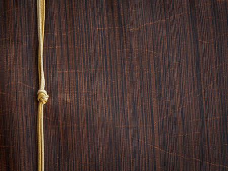 Background of white silk fabric texture with golden string .