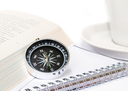 Compass with the book  on white background.の写真素材