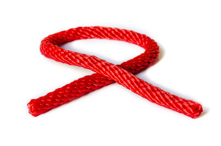 Red rope with a knot isolated on white Background .の写真素材