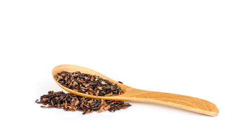 close up  of Thai rice berry with a wooden spoon or Thai black jasmine rice.の写真素材
