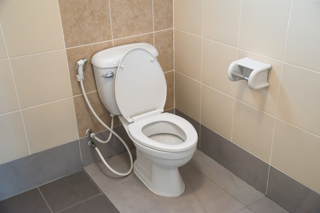White toilet bowl in a bathroom.の写真素材