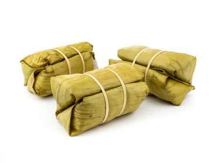 Thai dessert, Khao Tom Mad, steamed sticky rice with banana isolated on white.の写真素材