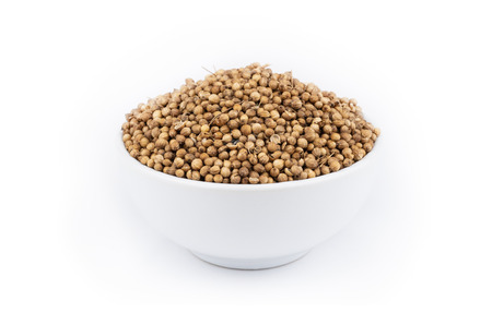 Pile of coriander seeds isolated on white background .の写真素材