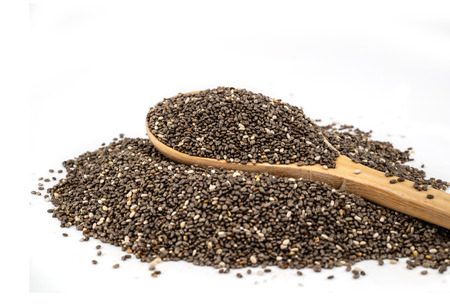 Healthy Chia seeds in a wooden spoon isolated on white.の写真素材