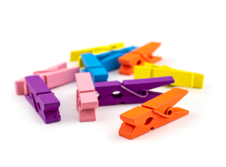colorful wooden clothes pin isolated on white.の写真素材