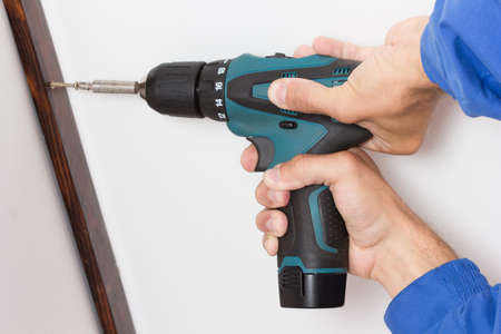 Hands with screw driver assembling interior element