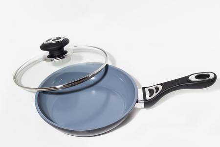 Frying pan with glass cover, isolated on a white background.の写真素材