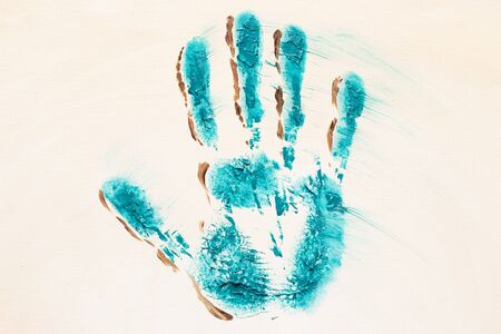 Oil painted turquoise handprint on white canvas backgroundの写真素材