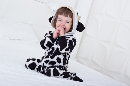 Baby in cow costumeの写真素材