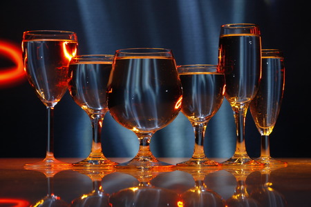 six glasses with water in lightの写真素材