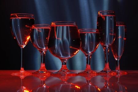 six glasses with water in lightの写真素材