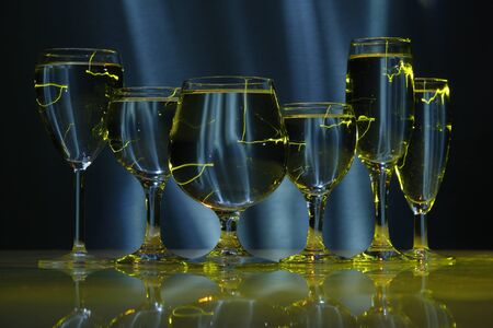 six glasses with water in lightの写真素材