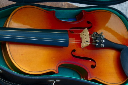 Old-fashioned violin on the green velvet background の写真素材