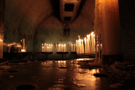 internal church with religious candles and lampのeditorial素材