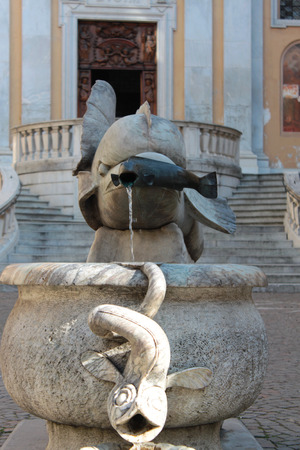 Fish sculpture fountain for drinking in the city centerの写真素材
