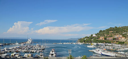 GIGLIO ISLAND, ITALY - JULY 18, 2014 Boats in the small harbor of  Porto Santo Stefano , the pearl of the Mediterranean Sea, Tuscany - Italyのeditorial素材