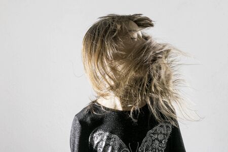 Portrait girl with fluttering hairの写真素材