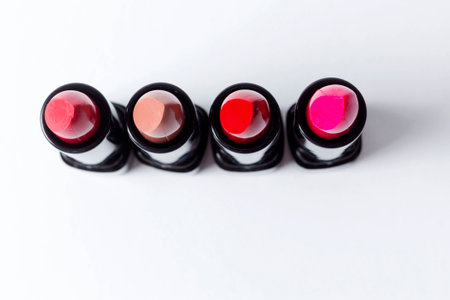 Four different colored lipsticks against white backgroundの写真素材