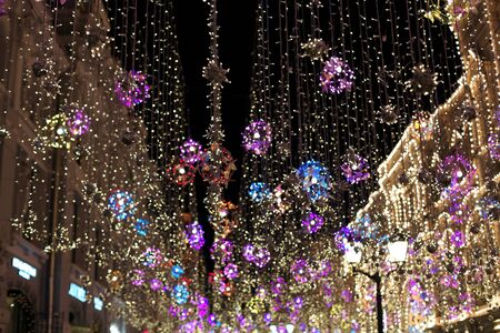 Christmas decorations on the street on the background of the Moscow Kremlin. Manezhnaya Square