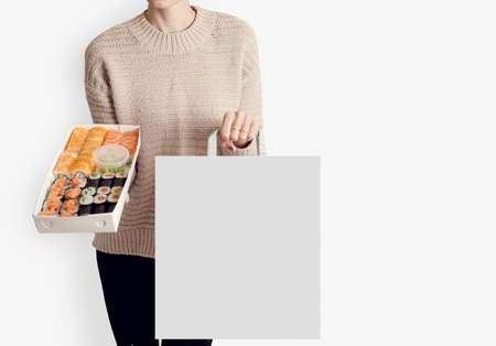 Unreconized woman holding srt of sushi delivery food white background copy space website bannerの写真素材