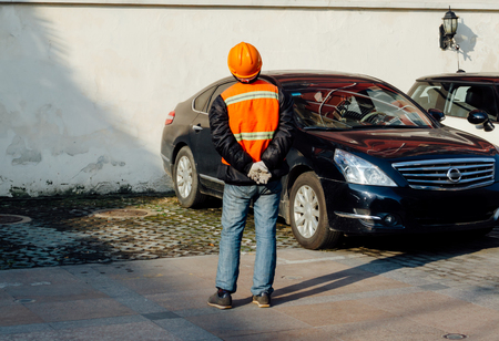 Structural engineer in orange work vests and hard bats looking upの写真素材