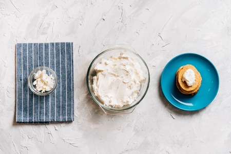 Bowl of cream cheese homemade in glass plate with pancakes and cottage cheese top viewの写真素材