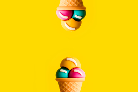 Ice cream cone plastic toy assorted flavors on a yellow background