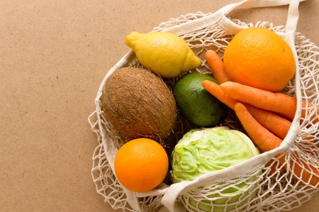 Eco friendly reusable mesh string knitted shopping bag with fruits and vegetables, zero wasteの写真素材
